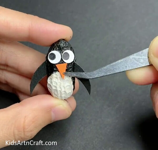 Attaching The Bill - A superbly designed penguin made out of peanut, styrofoam, and a paintbrush.