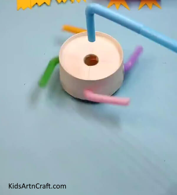 Paper Cup Spinning Toy Is Ready To Spin- A paper cup and straws can be used to make a fun spinning toy for kids.
