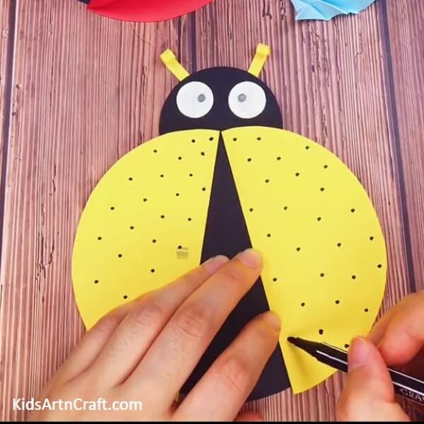 Final touches- An easy-to-follow Ladybug craft tutorial for Kindergartners.