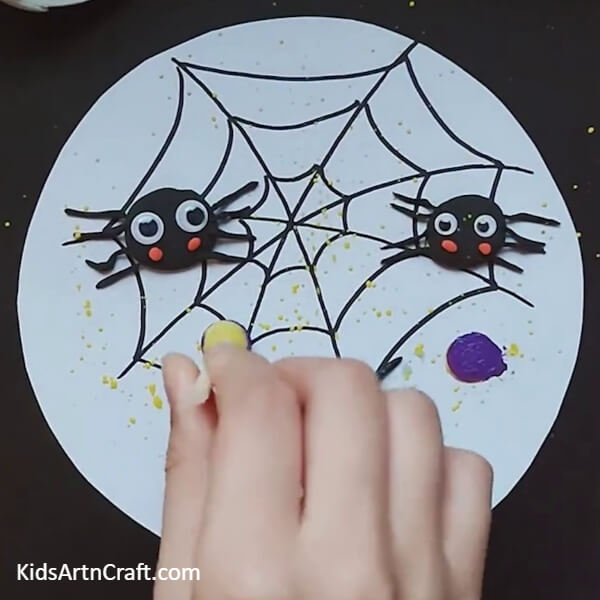 Dab purple colour with sponge- Step-by-step guide to create a cute little spider on web craft for kids