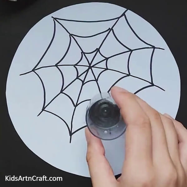 Put the black clay in a small glass-An Easy To Follow Spider Web Craft For Children