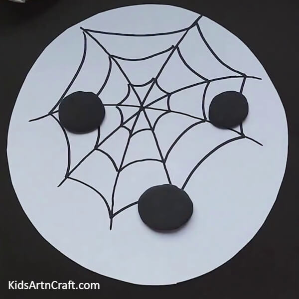 Make three black balls from black clay-A Step-By-Step Guide To Crafting A Spider Web For Kids