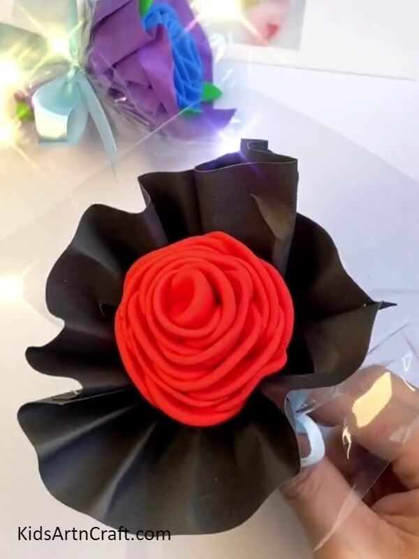 Wrapping The Sheet Around The Rose-Kid-friendly Clay Rose Bouquet craft to create 