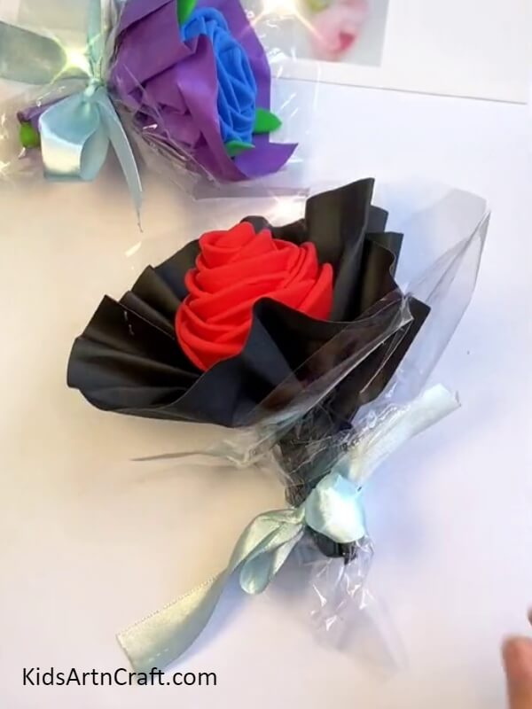Finally, The Tying The Ribbon On The Plastic Cover-An uncomplicated Clay Rose Bouquet craft for little ones 