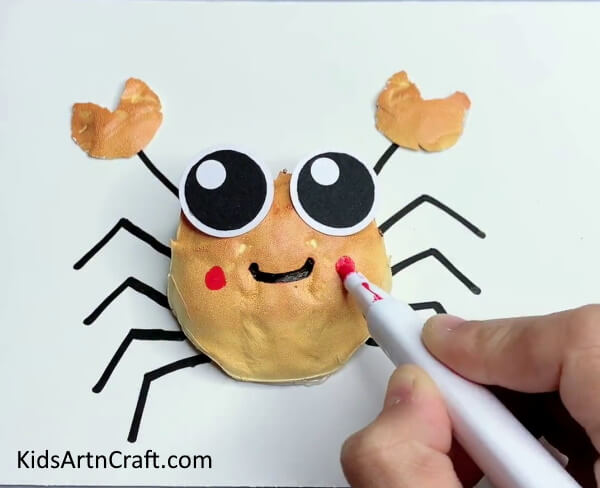 Adding More Features To The Bun-Making A Crab Craft With Your Toddler Is A Piece Of Cake