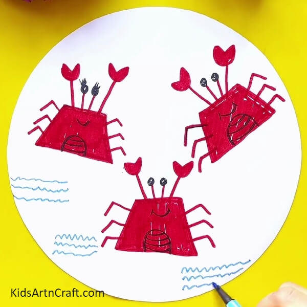 Drawing water with blue sketch pen- Follow the Steps to Create a Crab Drawing Using a Sketch Pen 