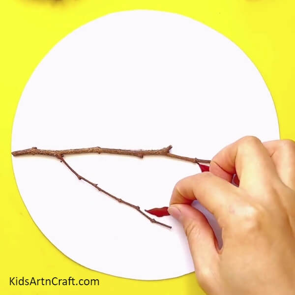 Pasting A Small Leaf On The Sheet-A Step-By-Step Guide For Creating A Fun Fall Leaves Bird Craft For Kids 
