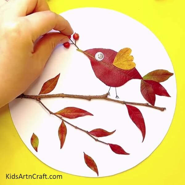 Pasting The Berries On The Sheet-An Illustrated Tutorial On Creating A Fall Leaves Bird Craft With Kids 