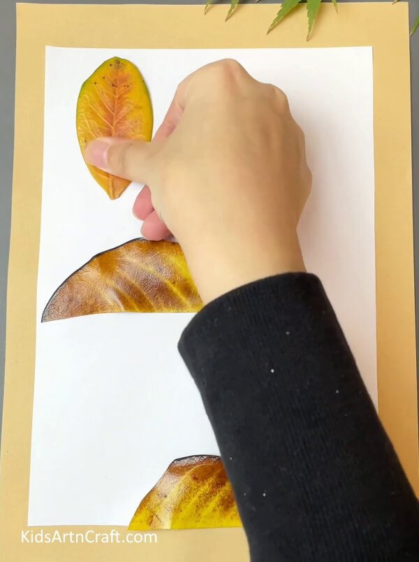 Take small leaf and start sticking them- How To Create Fun Fall Leaves Crafts For Children
