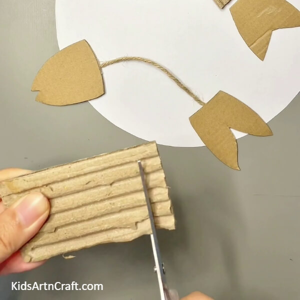 Cutting A Piece Of Cardboard For Making Gills - Crafting a Fish from Cardboard, Not Difficult 