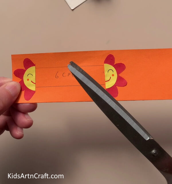 Cutting The Orange Strip -Incredible Flower Paper Rings Accessories Artwork For Kids To Manufacture At Home