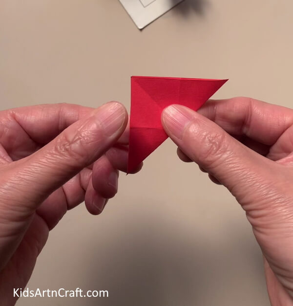 Folding The Red Paper In A Triangle - Great Flower Paper Rings Jewelry Project For Kids To Construct At Home