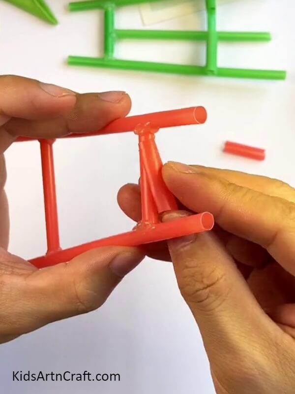 Fitting The Piece Into The Structure-A Step-by-Step Tutorial for Making a Mobile Phone Holder Using Straws for Children 