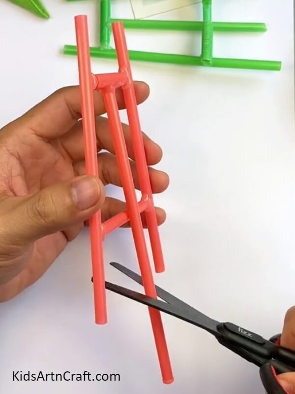 Trimming The Excess Straw Off-A Simple Tutorial for Constructing a Mobile Phone Holder Out of Straws for Youngsters 
