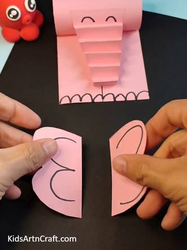 Making ears for elephant with pink paper- Quick And Simple Paper Elephant Projects For Kids