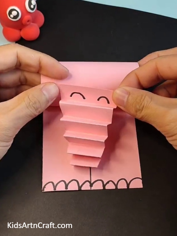 Pasting elephant trunk with elephant head- Making Paper Elephant Ideas For Kids To Enjoy 