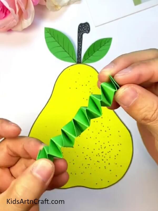 Folding The Paper Such That It Form Folds Like This - A Kid-Friendly Tutorial for Crafting a Pear-Fruit Worm