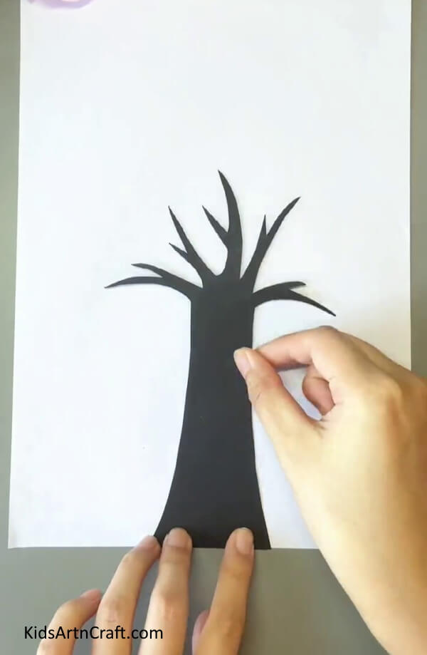 Pasting The Tree Over White Sheet-Earbuds can facilitate a simple tree painting for kids