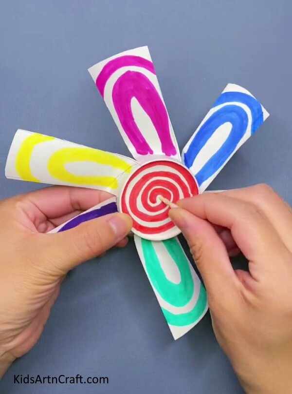 Put The Earbud In The Middle Of The Fan-Assembling a Windmill Fan Toy for Children Using a Paper Cup