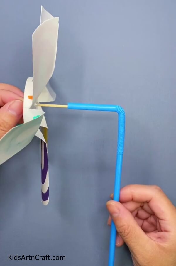 Put The Foldable Straw Inside The Earbud-Assembling a Windmill Fan Toy for Children Using a Paper Cup