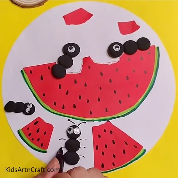 Drawing legs and antenna for ants- Artistic Fun with Watermelon Ants – A Children’s Activity