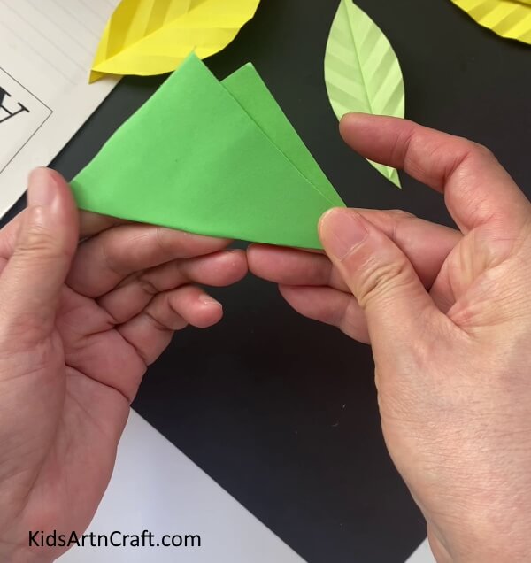 Folding The Green Paper In Mountain Shape A step-by-step guide to teaching kids to fold a paper leaf