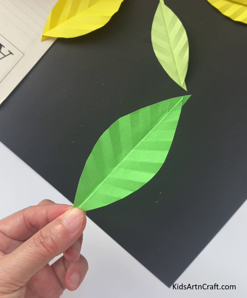 This Is The Final Look Of Our Folded Paper Leaf Craft! An instructional manual on producing a paper leaf for kids