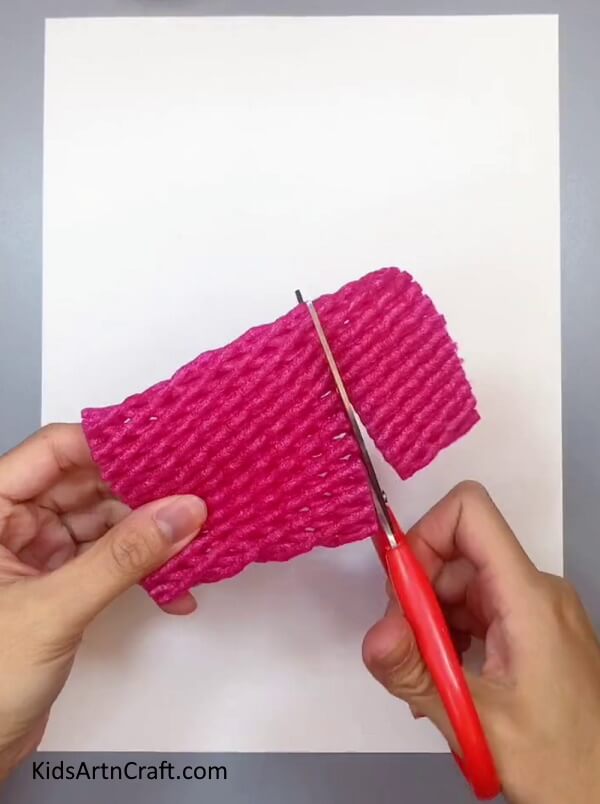 Cutting A Fruit Foam Net - Crafting a decoration out of fruit foam net and flowers at home.
