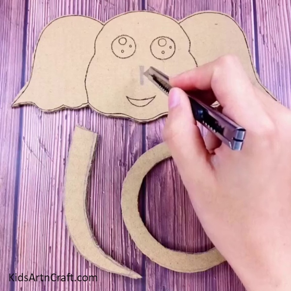 Cutting The Drawing With A Knife Or Scissors-Step-by-Step Guide to Crafting a Fun Elephant Ring Toss Game for Kids