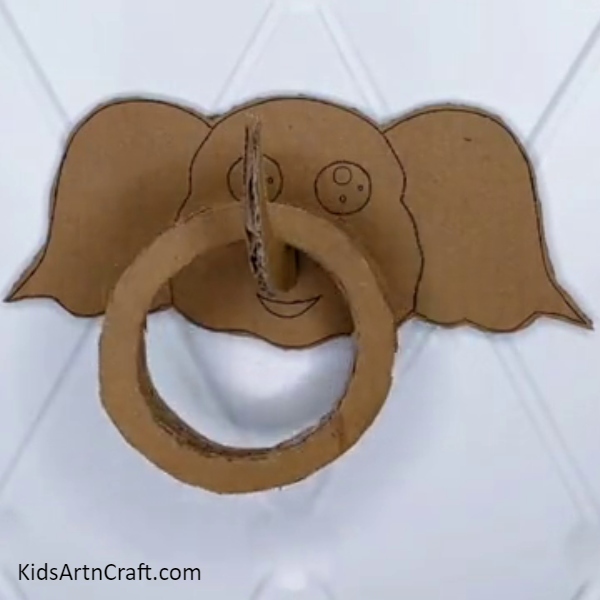 Pasting The Elephant Craft Into The Wall-A Tutorial for Building a Fun Elephant Ring Toss Game for Children