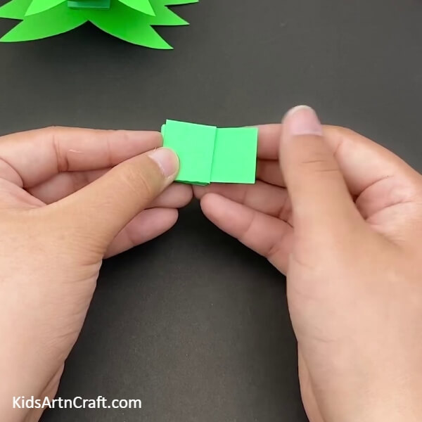 Folding the Strips on Top of Each Other- A playful paper frog craft activity for the children. 
