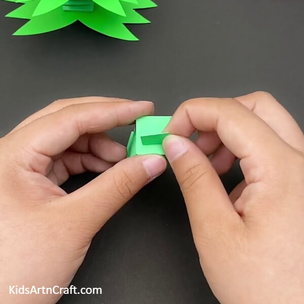 Pasting a Small Piece of Paper on Top of the Paper Spring- A fun paper frog craft that the kids can enjoy. 