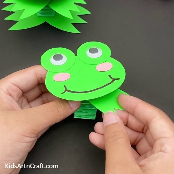 Pasting the Forelimbs-This paper craft of a jumping frog is sure to bring joy to youngsters. A playful paper frog craft activity for the children. An amazing paper frog craft that the little ones will love. A fun paper frog craft that the kids can enjoy. A creative paper craft project featuring a jumping frog. A leaping frog paper craft for the kids to make. A fun-filled paper craft for children that involves a frog jumping. Get the kids to make this delightful jumping frog paper craft. A jumping frog paper craft that will be a blast for the kids.