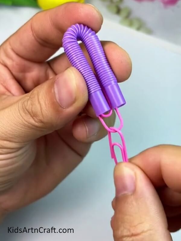 Inserting Pin Ends Into Straw - Follow These Steps To Make An Octopus Water Bottle Craft