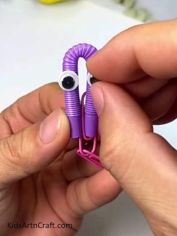 Pasting Doll Eyes With Straw - Making An Octopus Water Bottle Craft - A Kids Tutorial