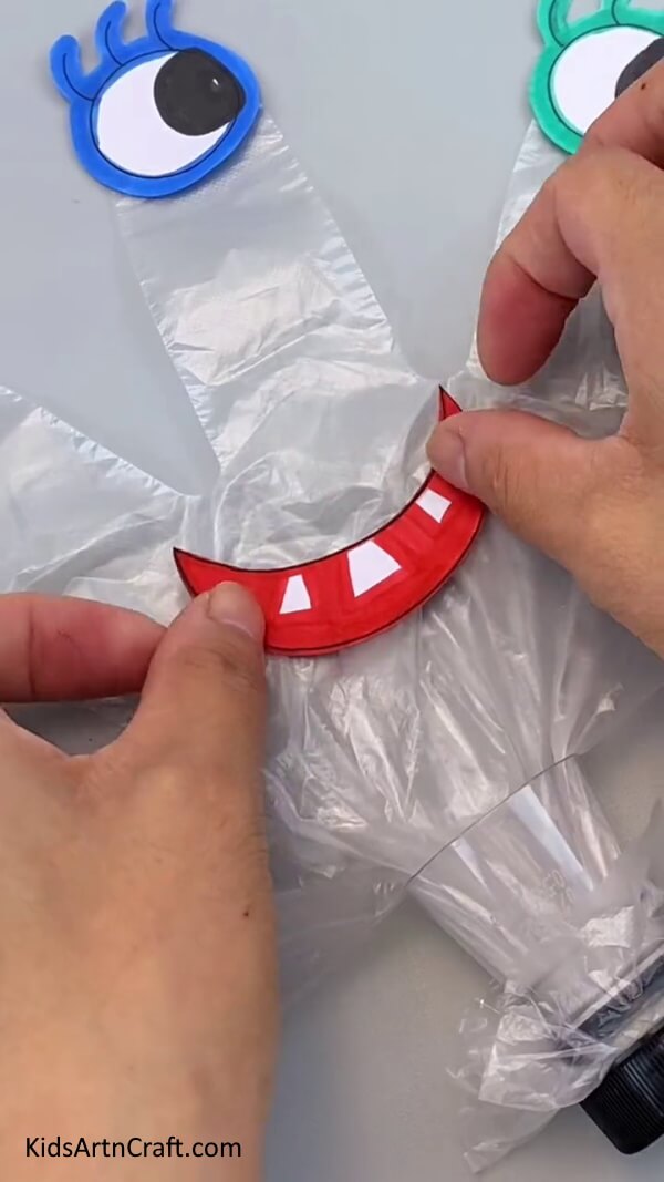Stick The Mouth On The Recycled Plastic Glove With Glue-Crafting Toys from Reused Objects - A Tutorial for Kids to Enjoy!