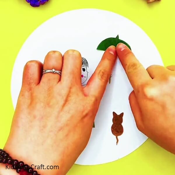 Making An Umbrella - Instructions on how to make a girl and cat in the rain craft out of leaves for kids 
