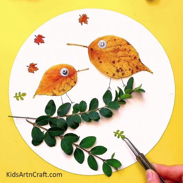 Sticking more different shaped fall leaf- Crafting a Fall Leaves Bird with your own hands - a tutorial for kids.
