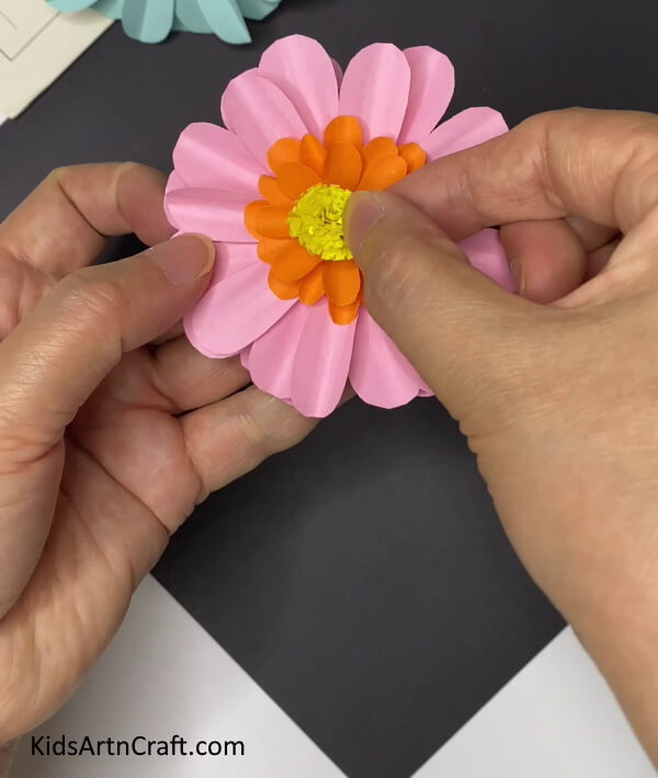 Pasting The Yellow Pistil At The Center -Crafting a Paper Flower Decoration for Home