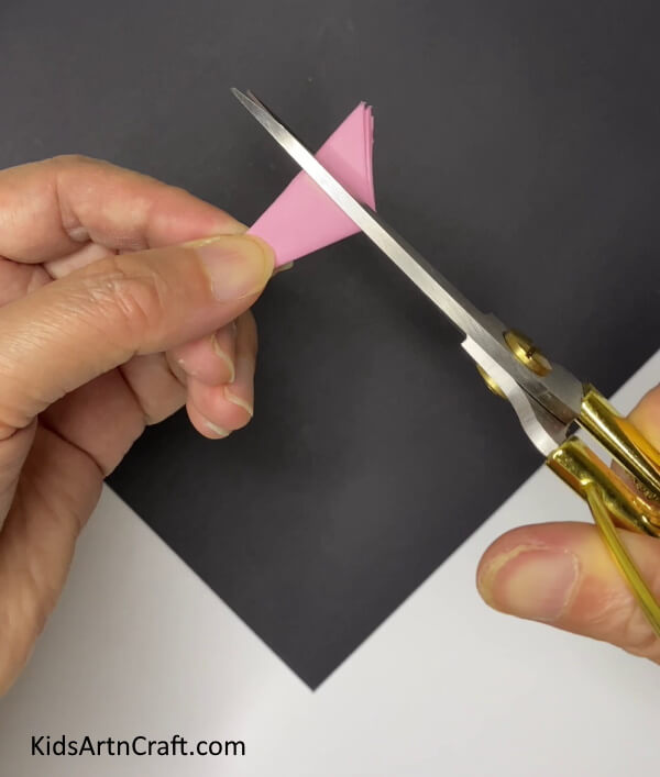 Cutting The Top Portion Of The Triangle -Creating Paper Flowers To Dress Up Your House