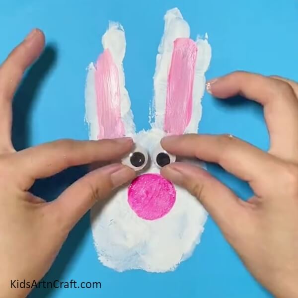Pasting Googly Eyes How to Create a Bunny with Handprints - Instructions 
