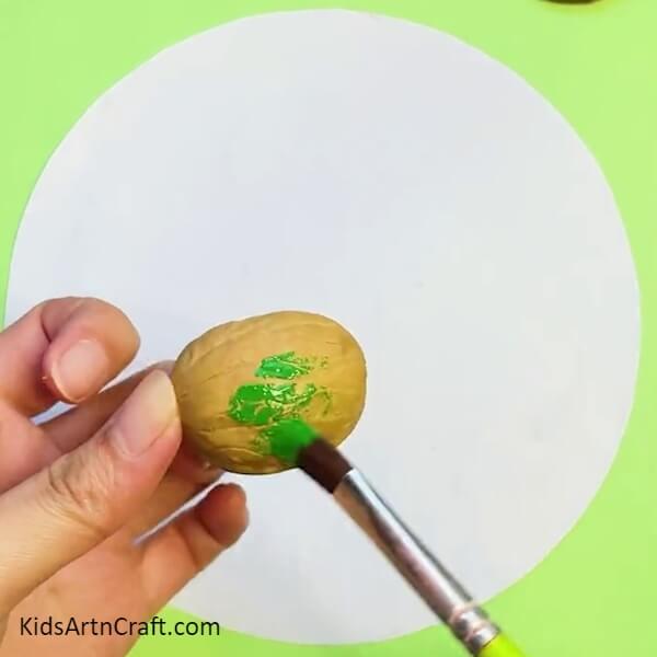 Painting Walnut Shells With Green Color Paint-