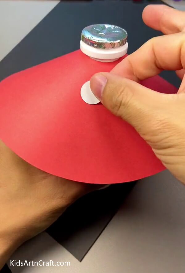 Cutting Small White circles From The White Sheet - Putting together a 3-dimensional Mushroom out of paper and a plastic bottle