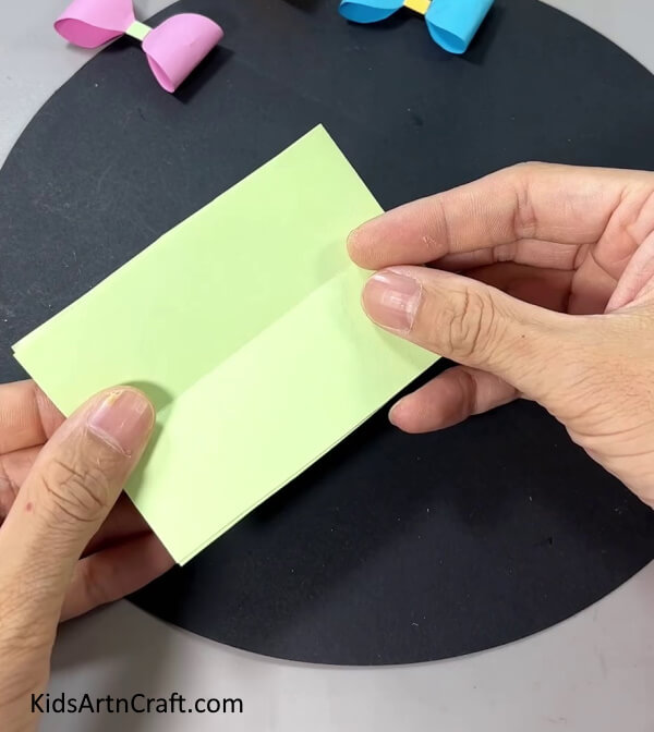 Folding Paper In Half - This simple guide will show kids how to assemble a paper bow.