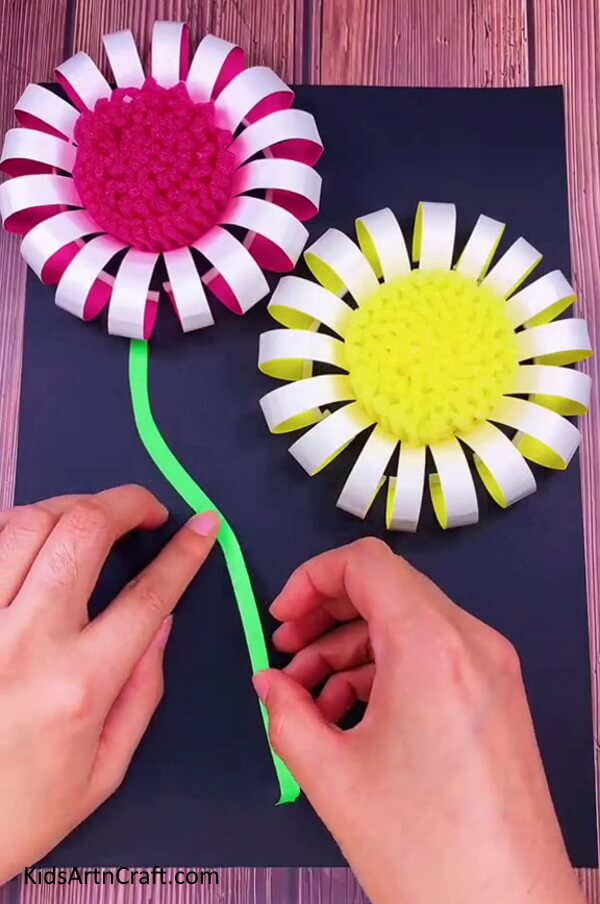 Adding The Stems To The Flowers - Learn how to make a Paper Cup Flower with kids in a few easy steps.