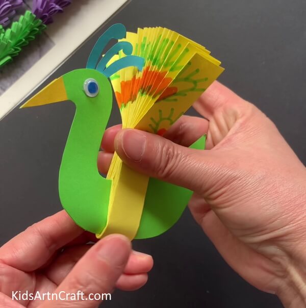 Attaching Wings To Body - Constructing a Peacock from Paper with the Little Ones