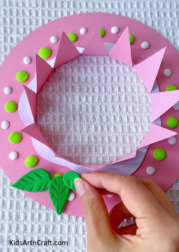 Use White And Dark Green Clay To Add To The Decorations- Fashioning a summer hat out of paper and clay for children