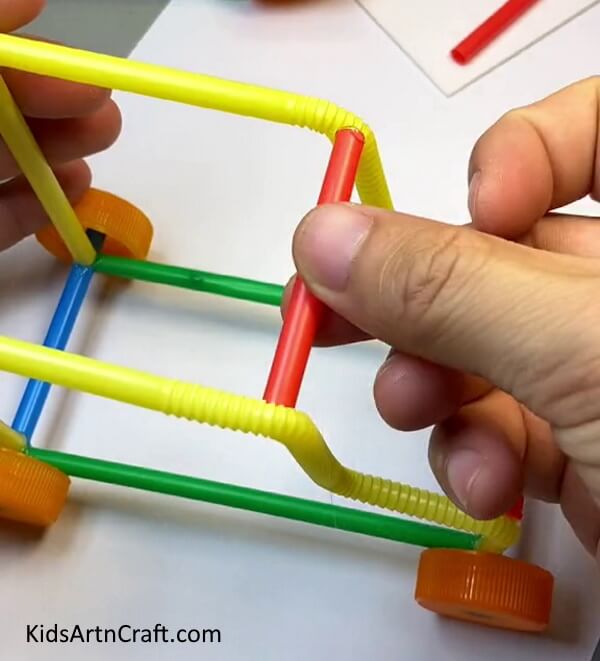 Pasting Another Red Straw-A step-by-step guide to creating a Toy Car from straw, perfect for kids