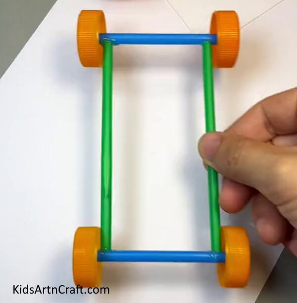 Sticking The Wheels With Each Other-Building a Toy Car with Straws - A Guide for Children