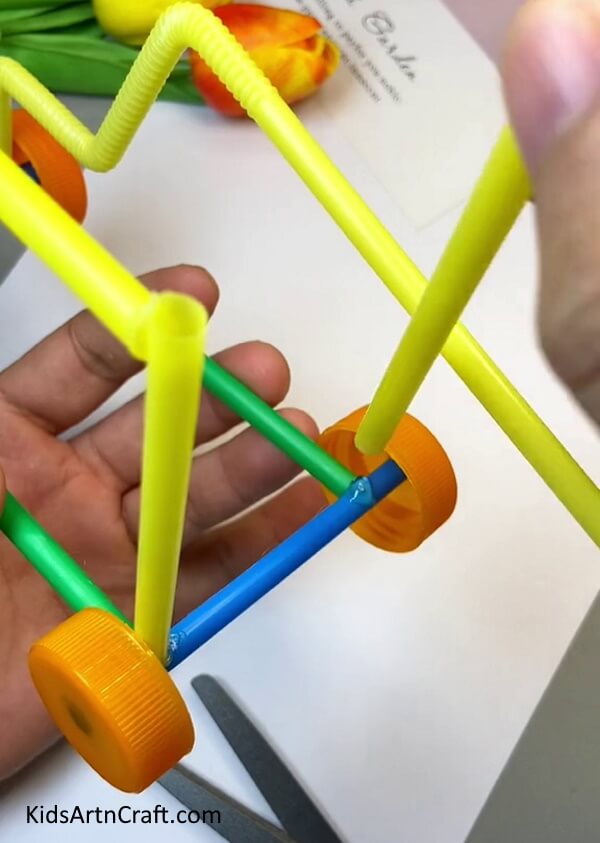 Pasting Straws At The Back Corners Of The Rectangle-How to Assemble a Toy Car from Straws - A Guide for Kids
